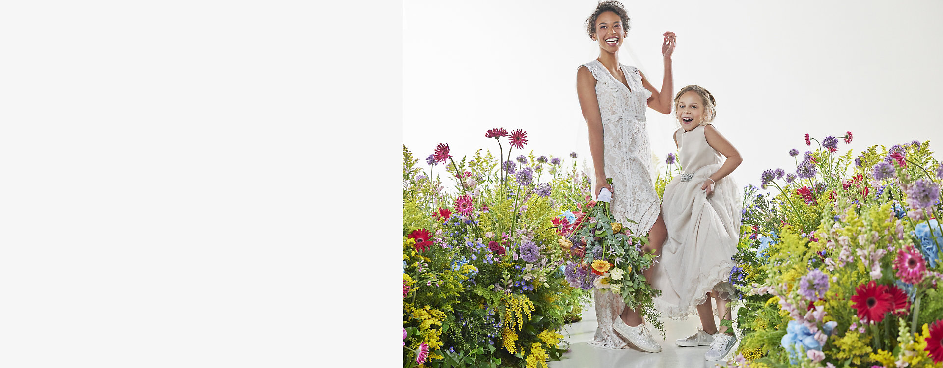 An adult and youth model surrounded by flowers, wearing formal dresses and shoes from the celebrations collection.