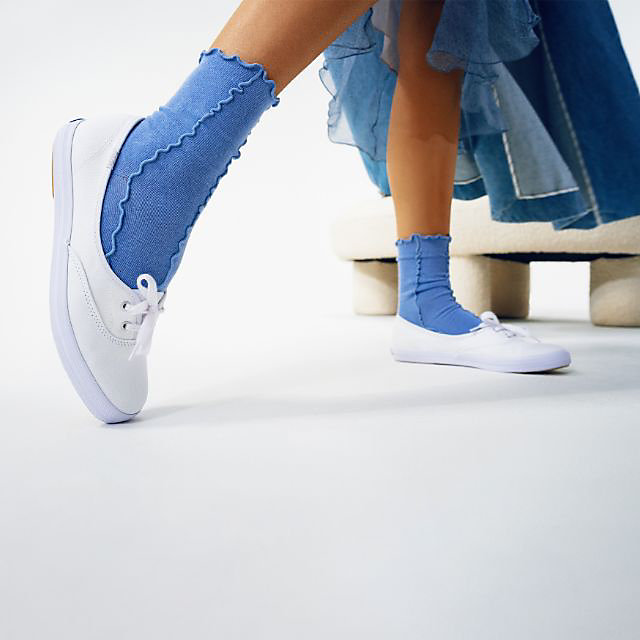 A model wearing a pair of the mini shoes.